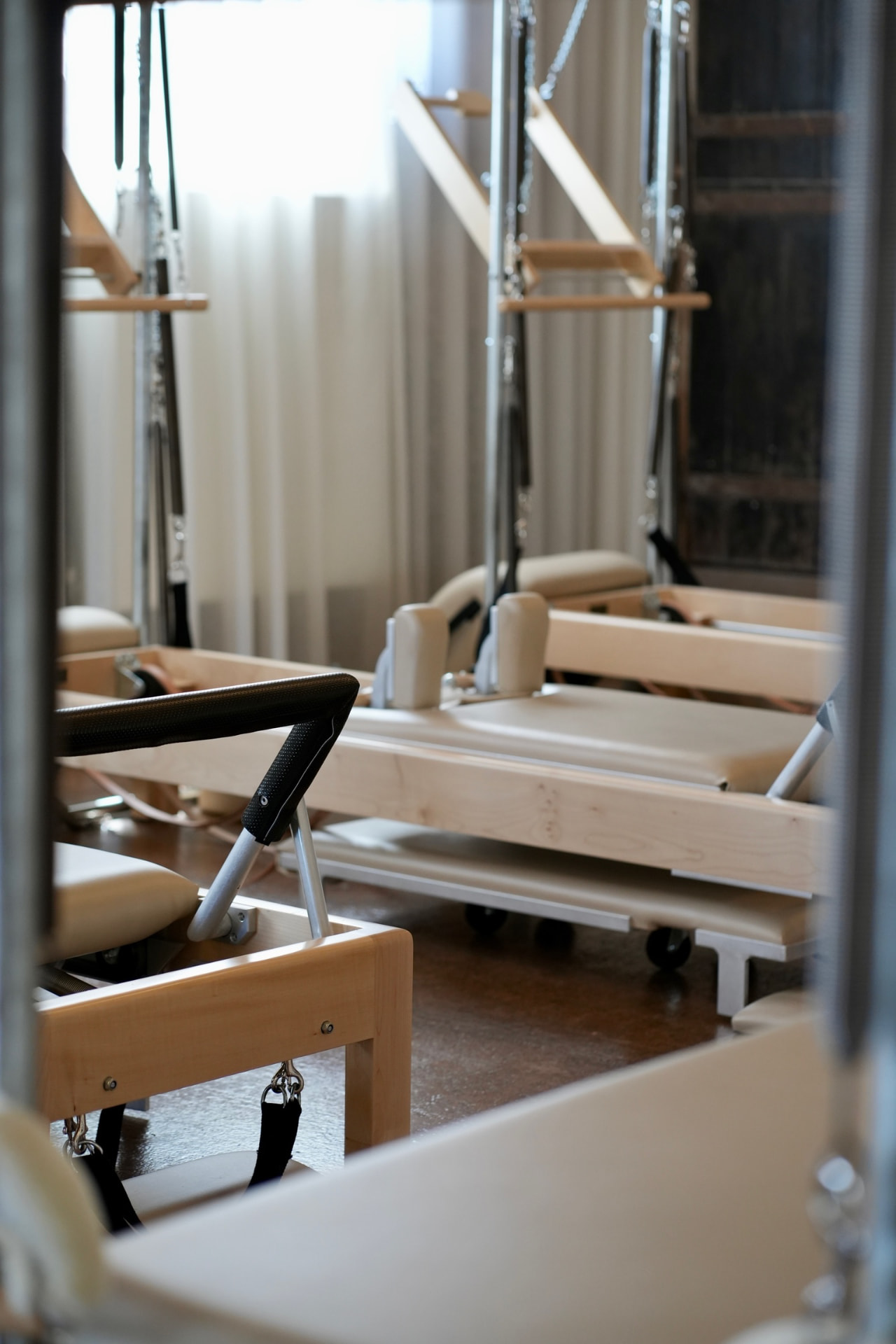 The Coconut studio seen across the room — reformers, tower and Wunda Chair in one frame