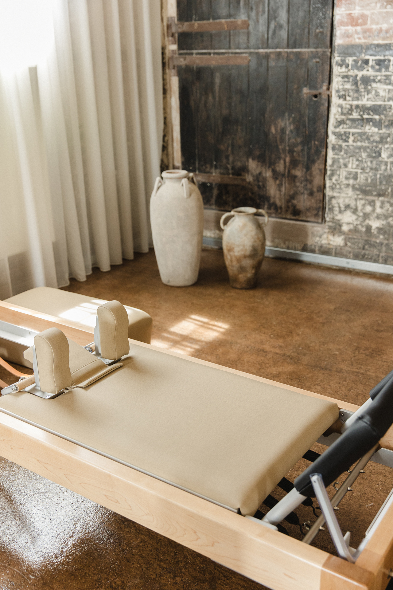 The Coconut studio — reformers, brick and morning light